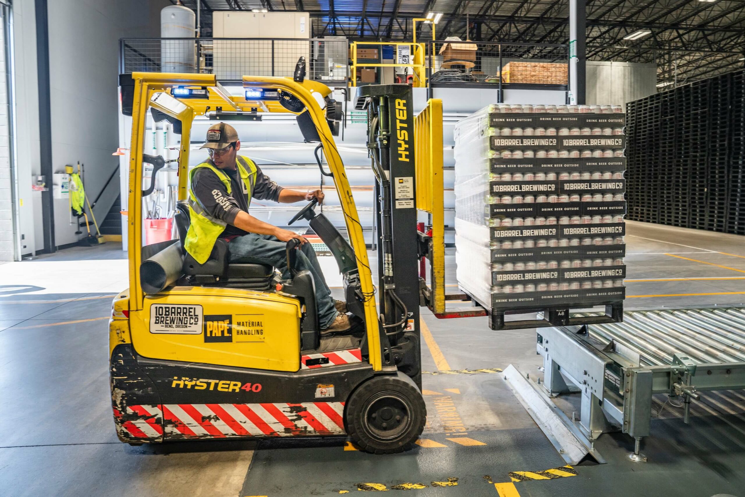 Man driving fork lift truck in a warehouse in the security industry