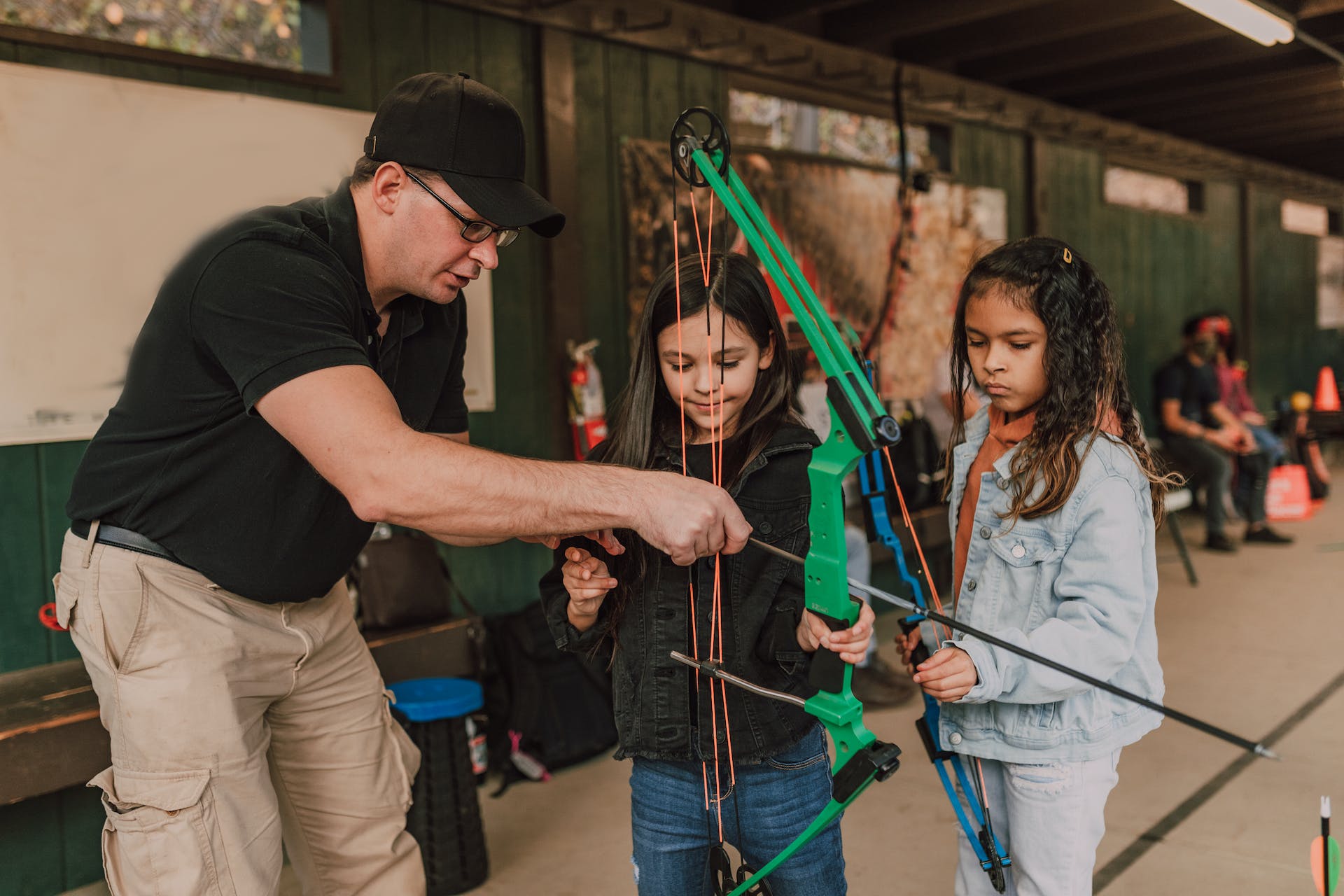 Image of a coach with children doing archery. What is a list 99 check?