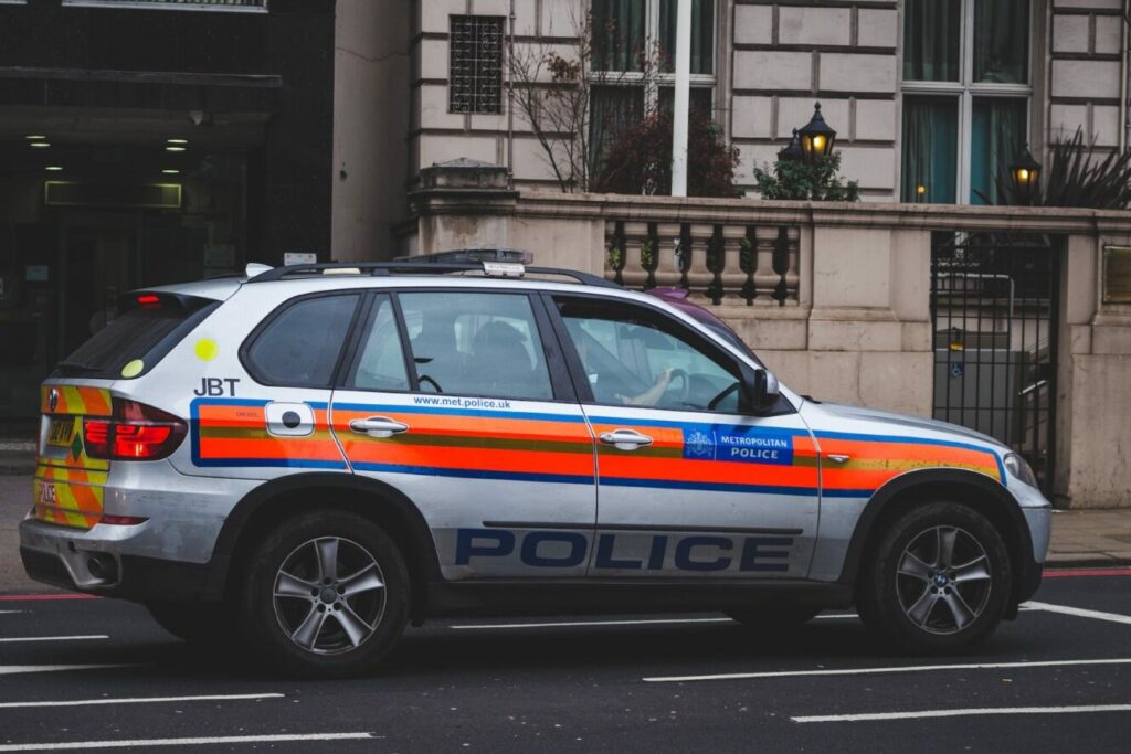 Criminal background check showing image of a met office police car in London