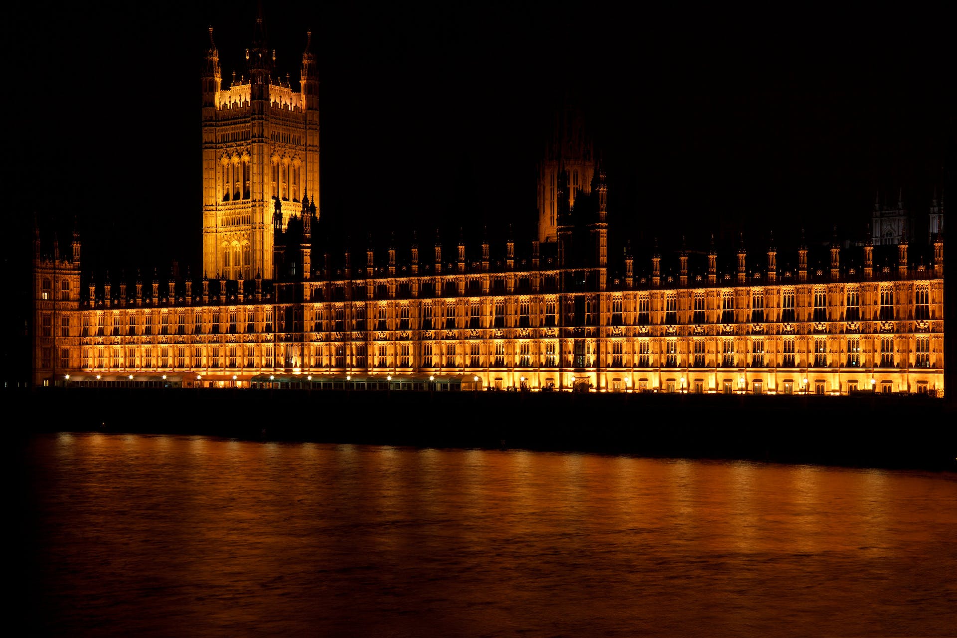 Houses of Parliament in London at night where legislation of right to rent checks are created and updated.